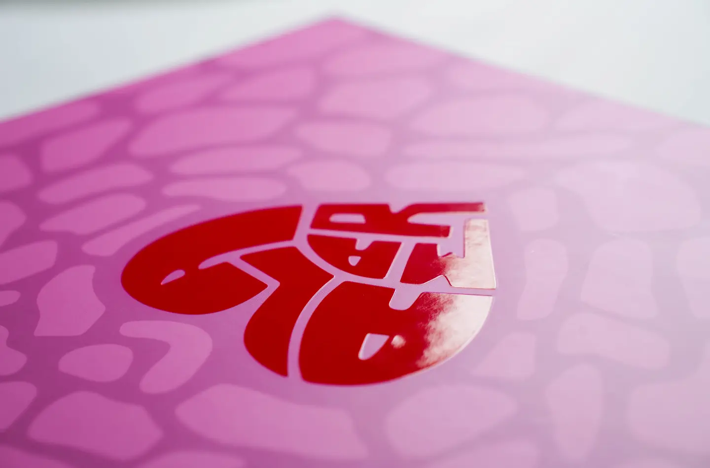Detail close-up of UV embossed heart design on high-end custom tea folding flip lid box with foam insert
