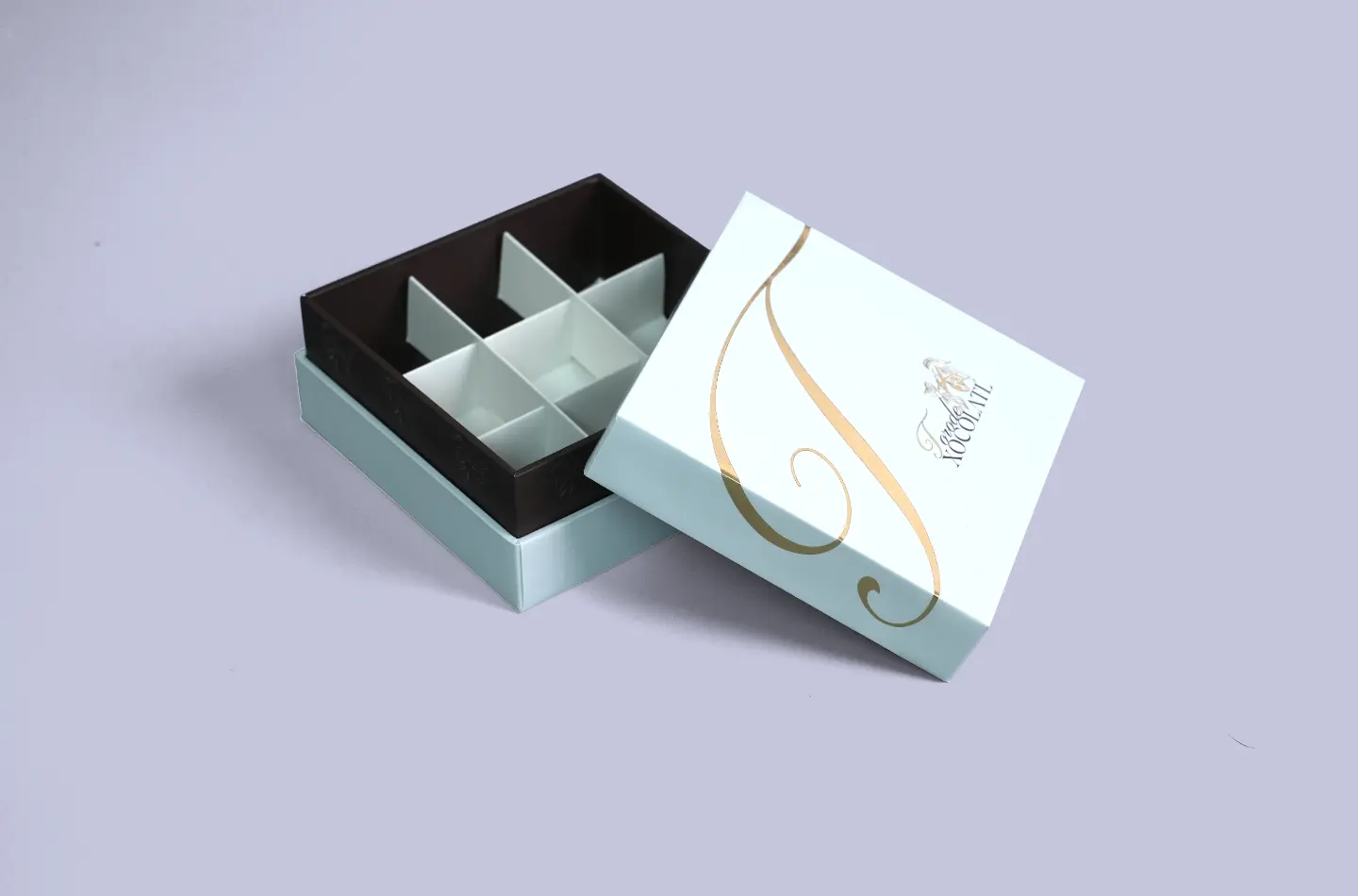 Luxury chocolate telescopic rigid box with gold foil finish, open to reveal the nine-compartment paper insert