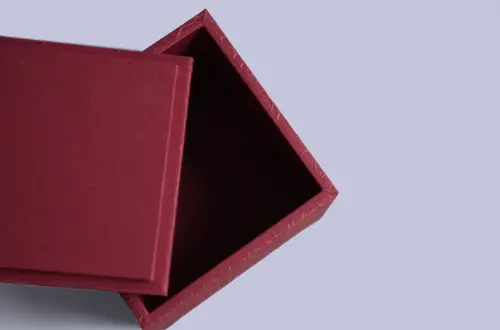 Overhead view showing the rear lid details of a two-piece embossed tea box opened