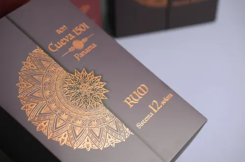 Detail shot highlighting the embossed and gold-stamped surface of a custom cosmetic tuck box