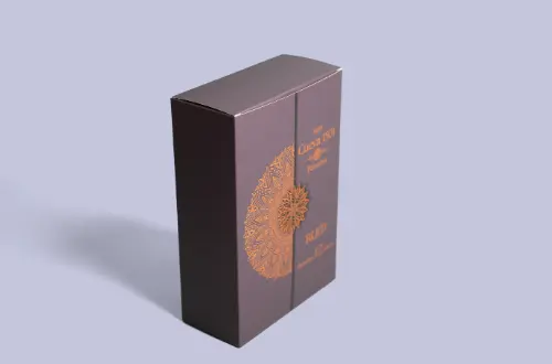 Embossed and gold-stamped cosmetic paper tuck box shown standing from a side-angle perspective