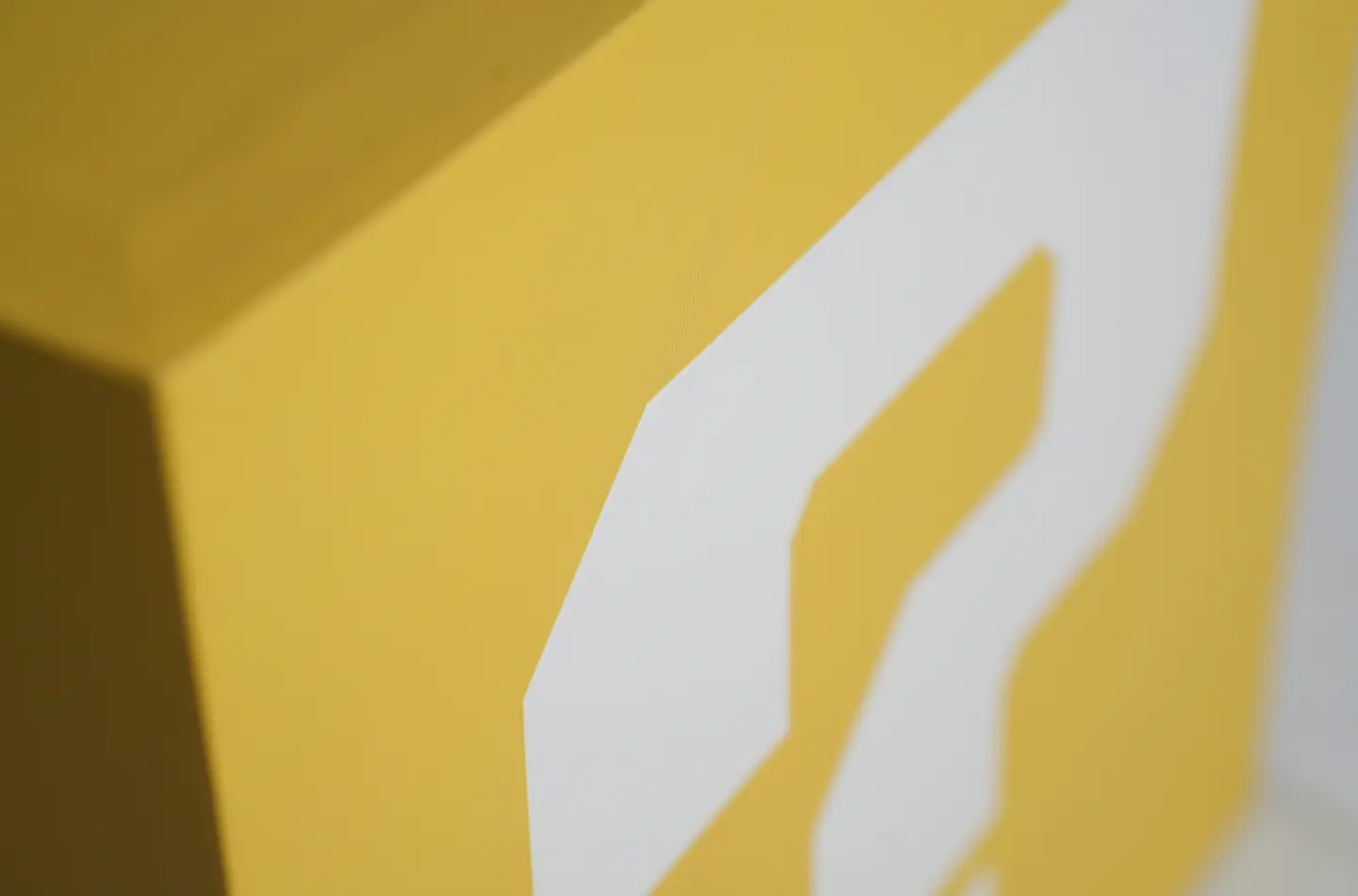 Detail shot showing screen printing on the exterior of a yellow two-piece telescopic box