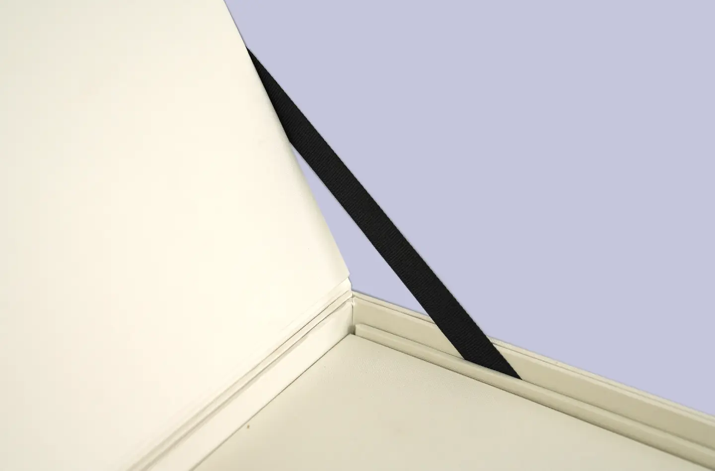 Side view detail showing ribbon and holographic gold accents on a double-layer flip-top drawer packaging box