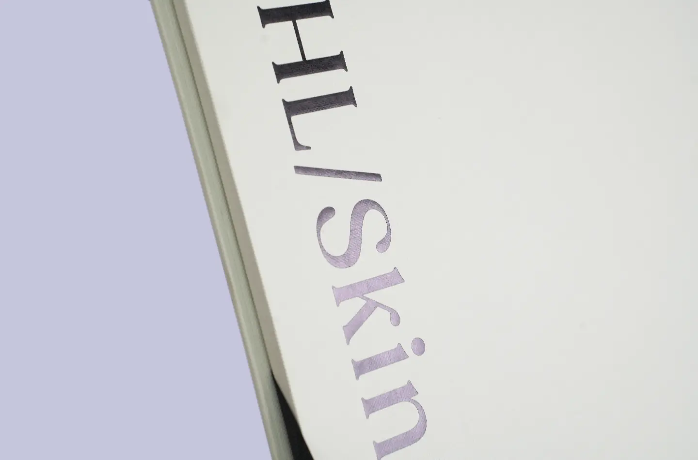 Detailed view showing black and holographic gold foil accents on a double-layer flip-top drawer packaging box