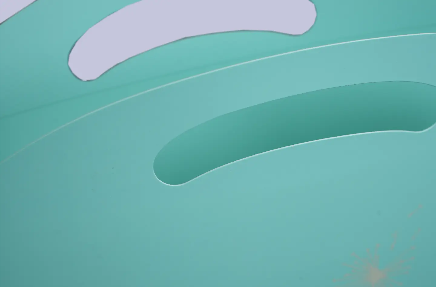 Detail view showing the top handle of a Tiffany blue seamless curved tote bag