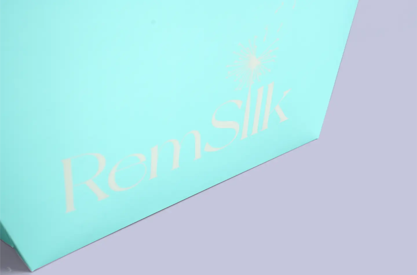 Detailed view showing the screen printing on the front of a Tiffany blue seamless curved tote bag