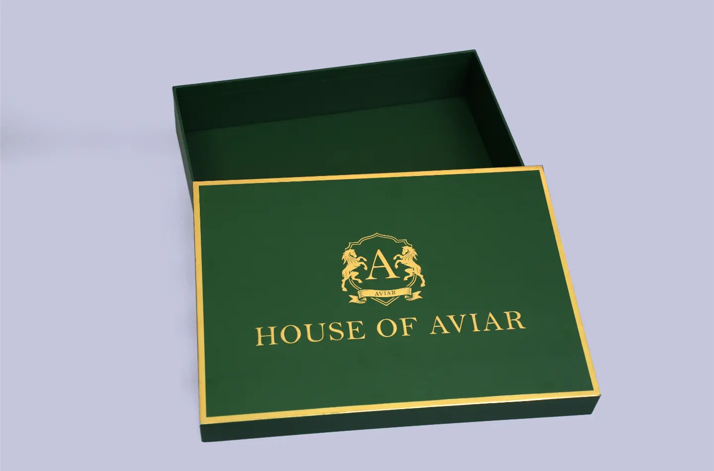 Open display of a high-end green rigid lid-and-base box featuring elegant gold foil details.