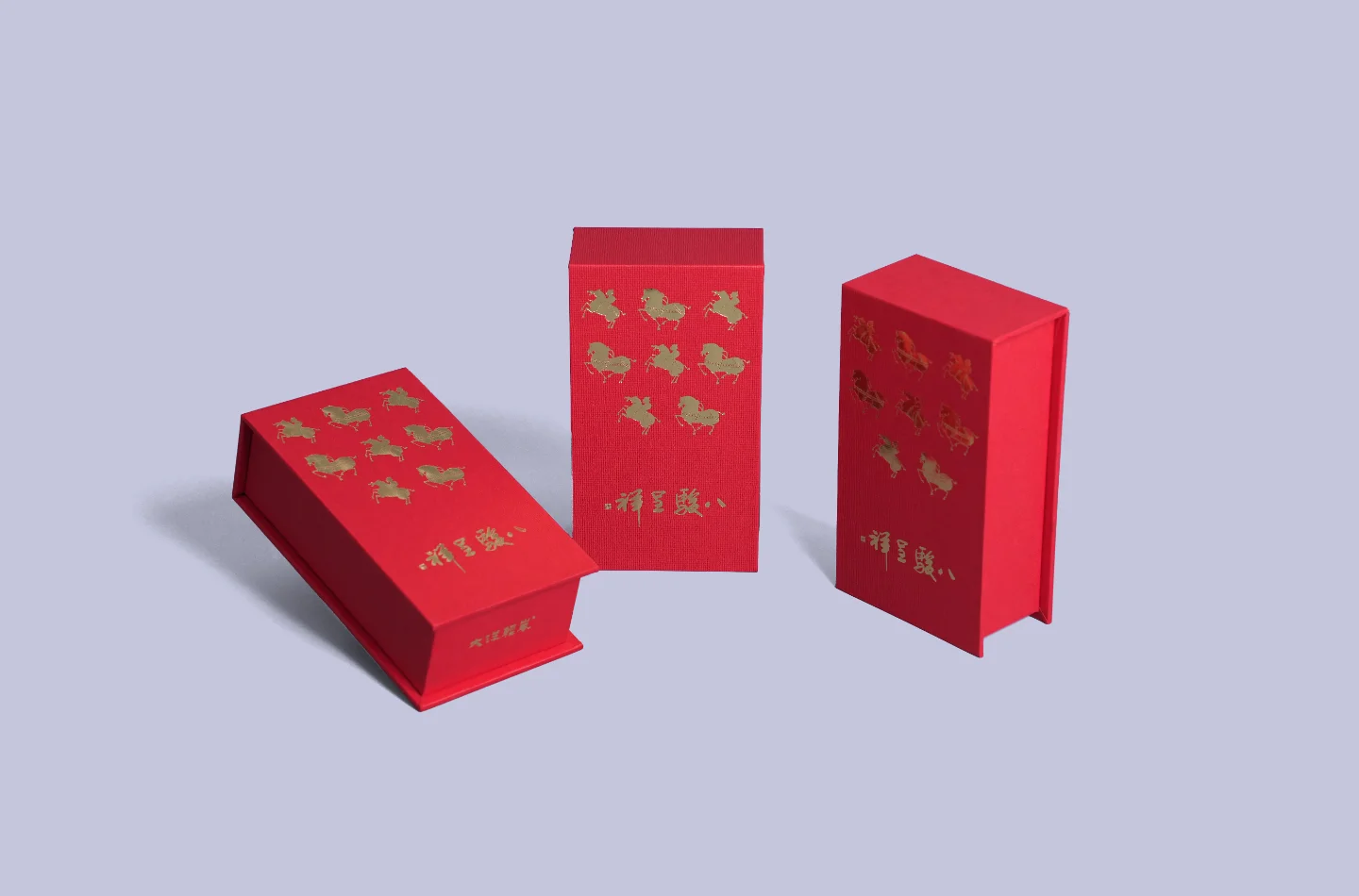 Three red flip-top boxes featuring gold foil decoration, shown from the front