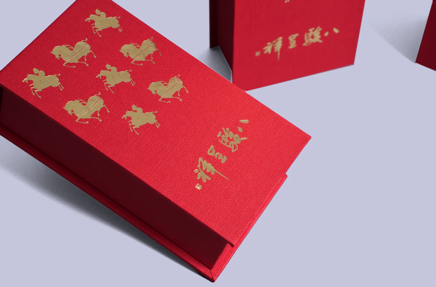 Detailed view showing the gold foil decoration on a red flip-top box