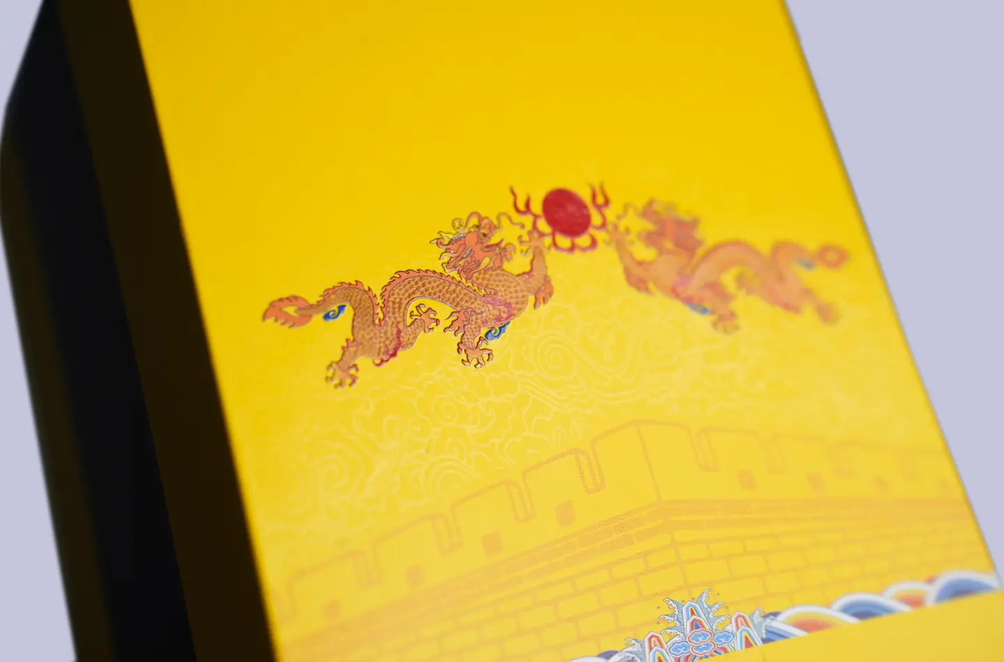 Gold magnetic flip-top box, detailed view of the embossed texture with UV printed effects