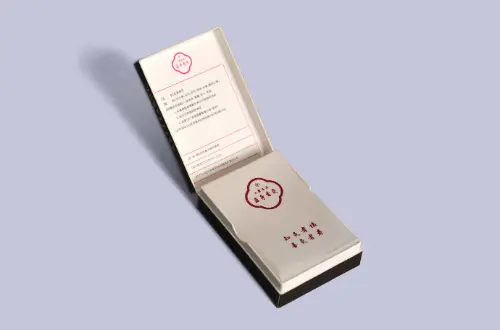 Opened custom flip-top paperboard box featuring laminated exterior and glassine paper lining, front-facing view