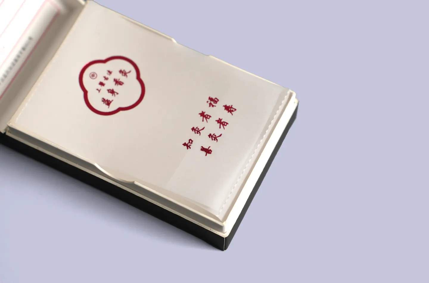 Detailed view of the interior showing glassine lining and gold foil on a custom laminated flip-top paperboard box