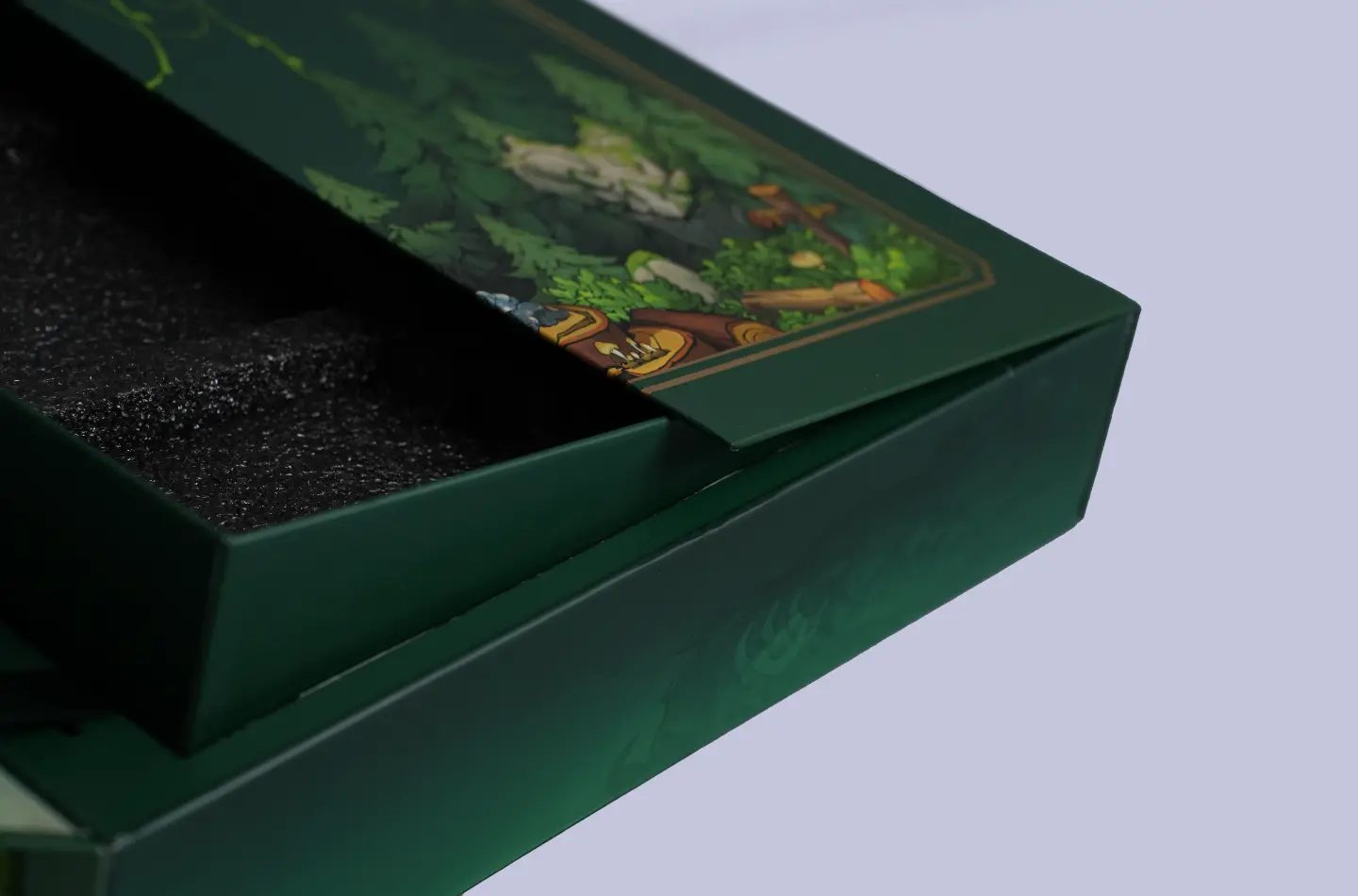 Half-open view of a high-end magnetic lift packaging box featuring gold foil finishing and built-in foam insert, showing interior details