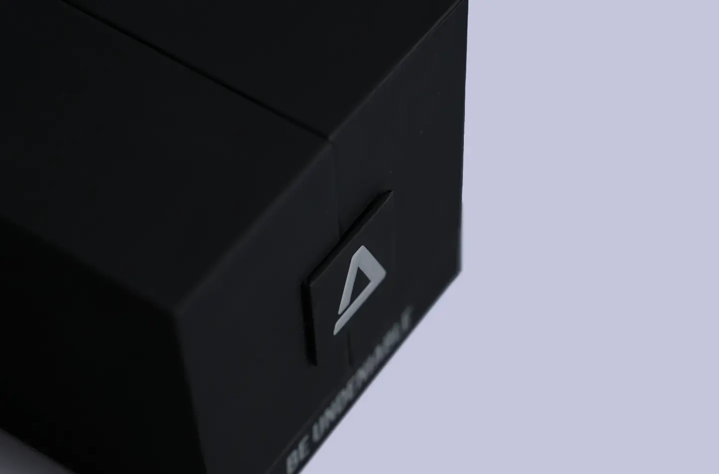 Overhead shot highlighting the magnetic closure feature of a high-end black box with silver foil stamping