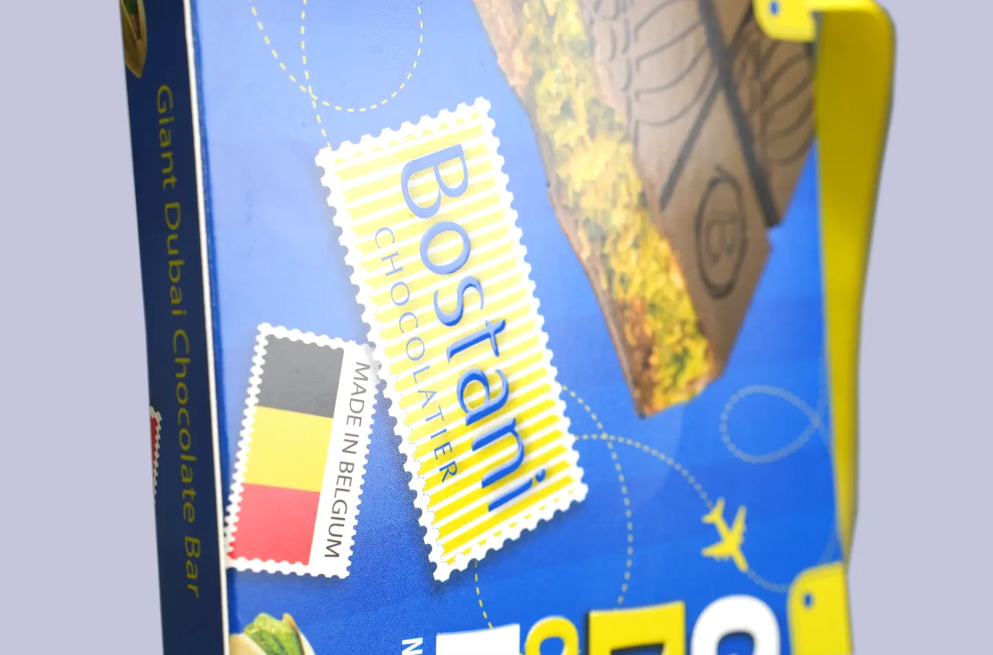 Custom paperboard box with handle and tuck-in flap, close-up showing surface print details