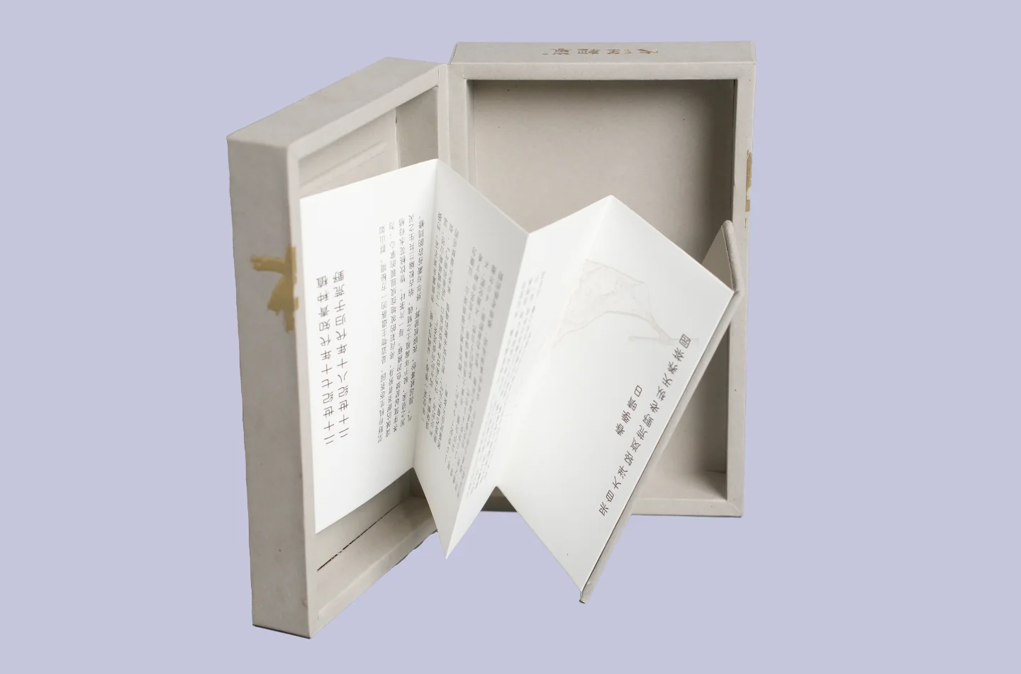 custom gray flip lid tea box for tea packaging with gold foil stamping and embossed surface, opened to showcase interior folded insert details