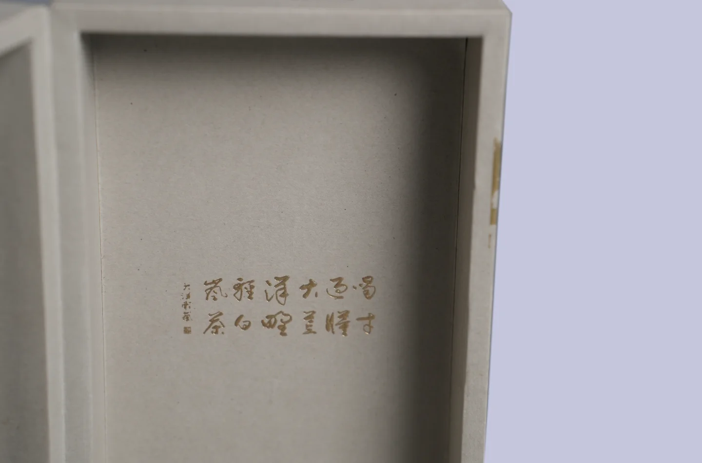 custom gray flip lid tea box for tea packaging with gold foil stamping and embossed surface, opened to showcase interior gold foil stamping details