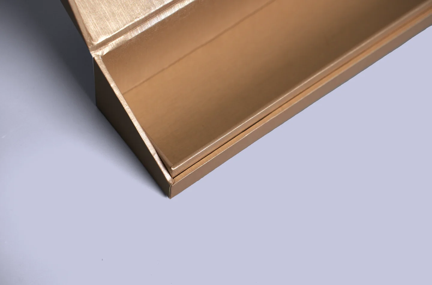 custom brown flip lid box for apparel packaging laminated with special pearlescent paper, opened to showcase interior details