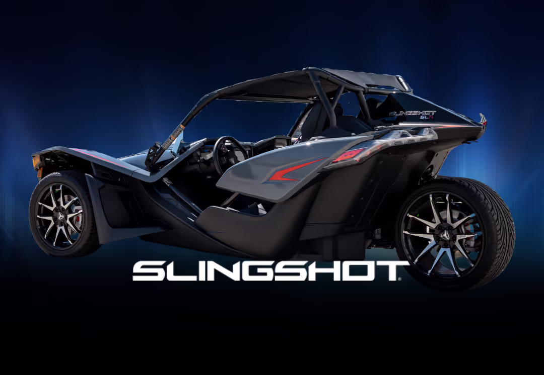 A beautifully displayed blue Polaris Slingshot with a blue background, available to rent in Houston