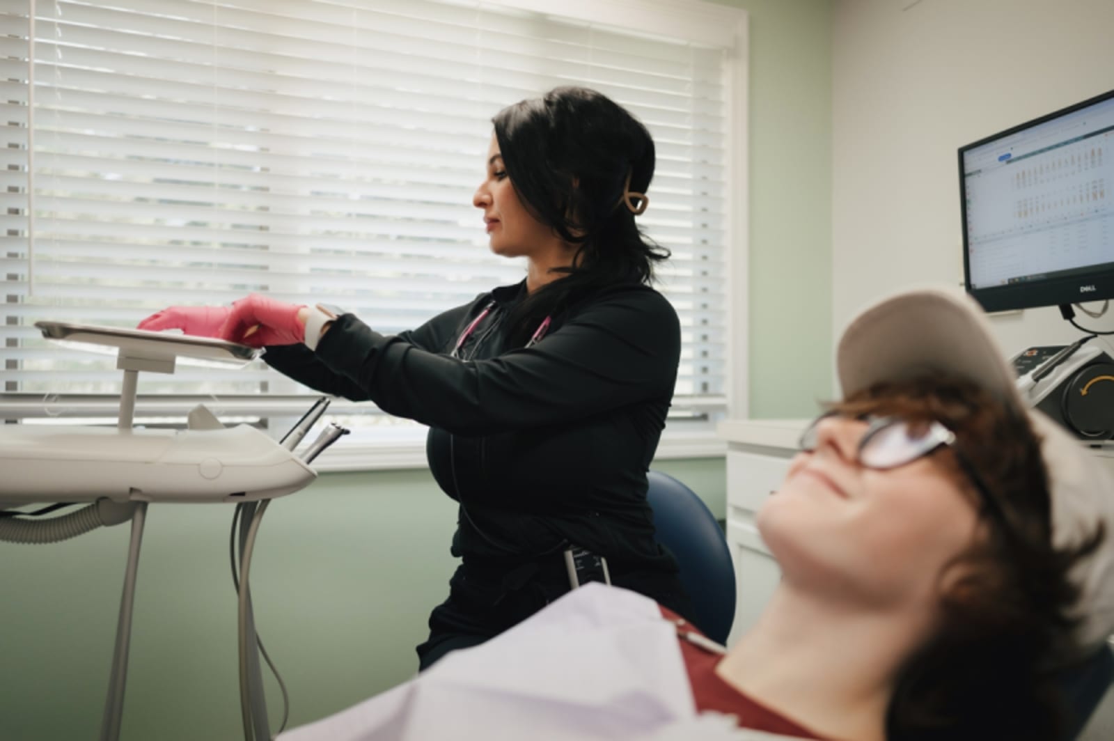 Dental professional performing scaling or periodontal treatment on patient
