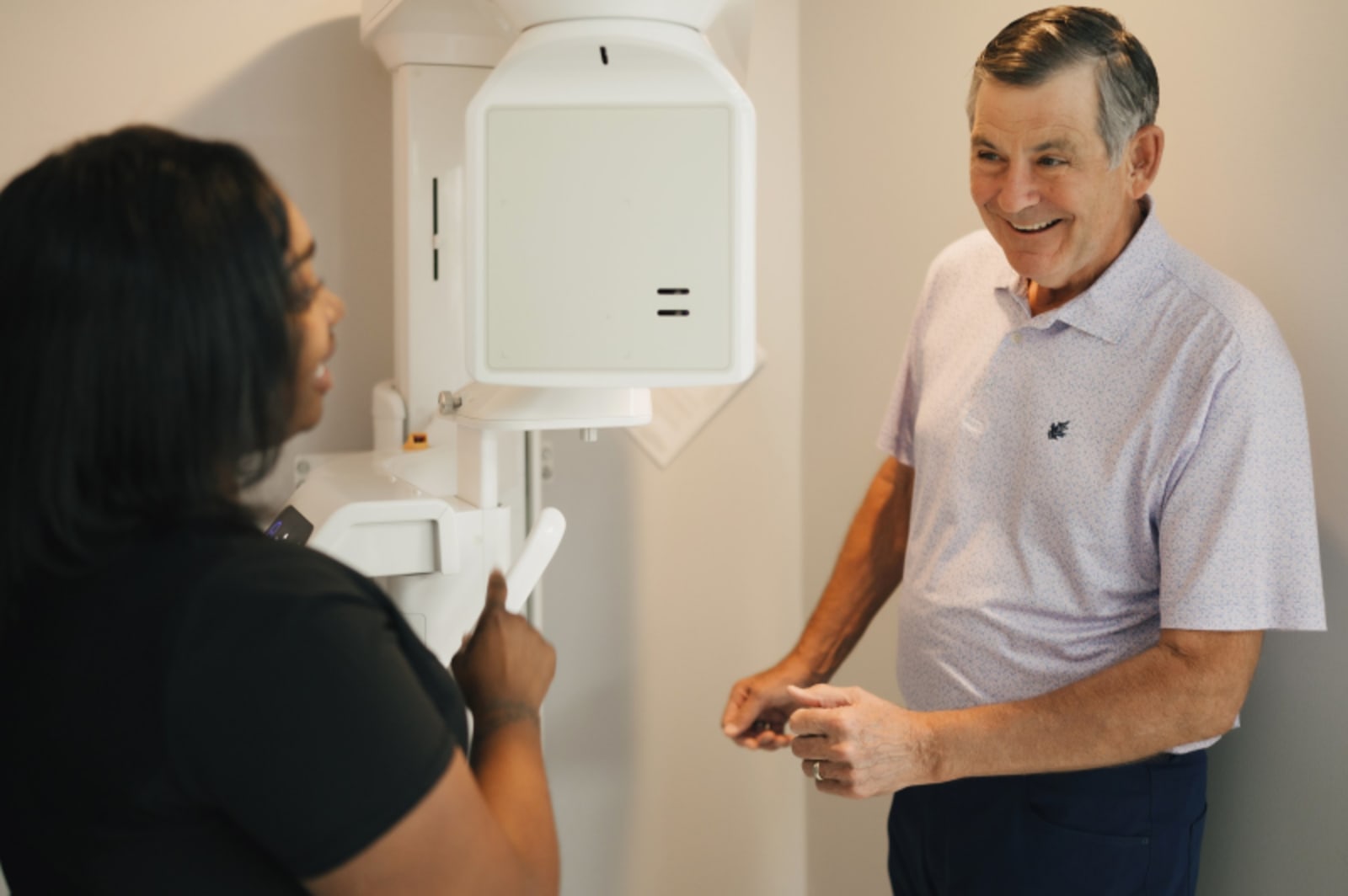 Dentist engaging in conversation with a patient, building rapport and trust