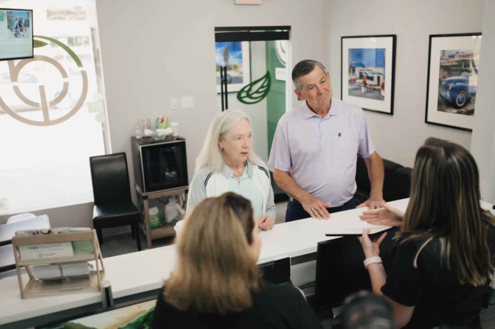Dentist consulting with patient at desk during treatment discussion