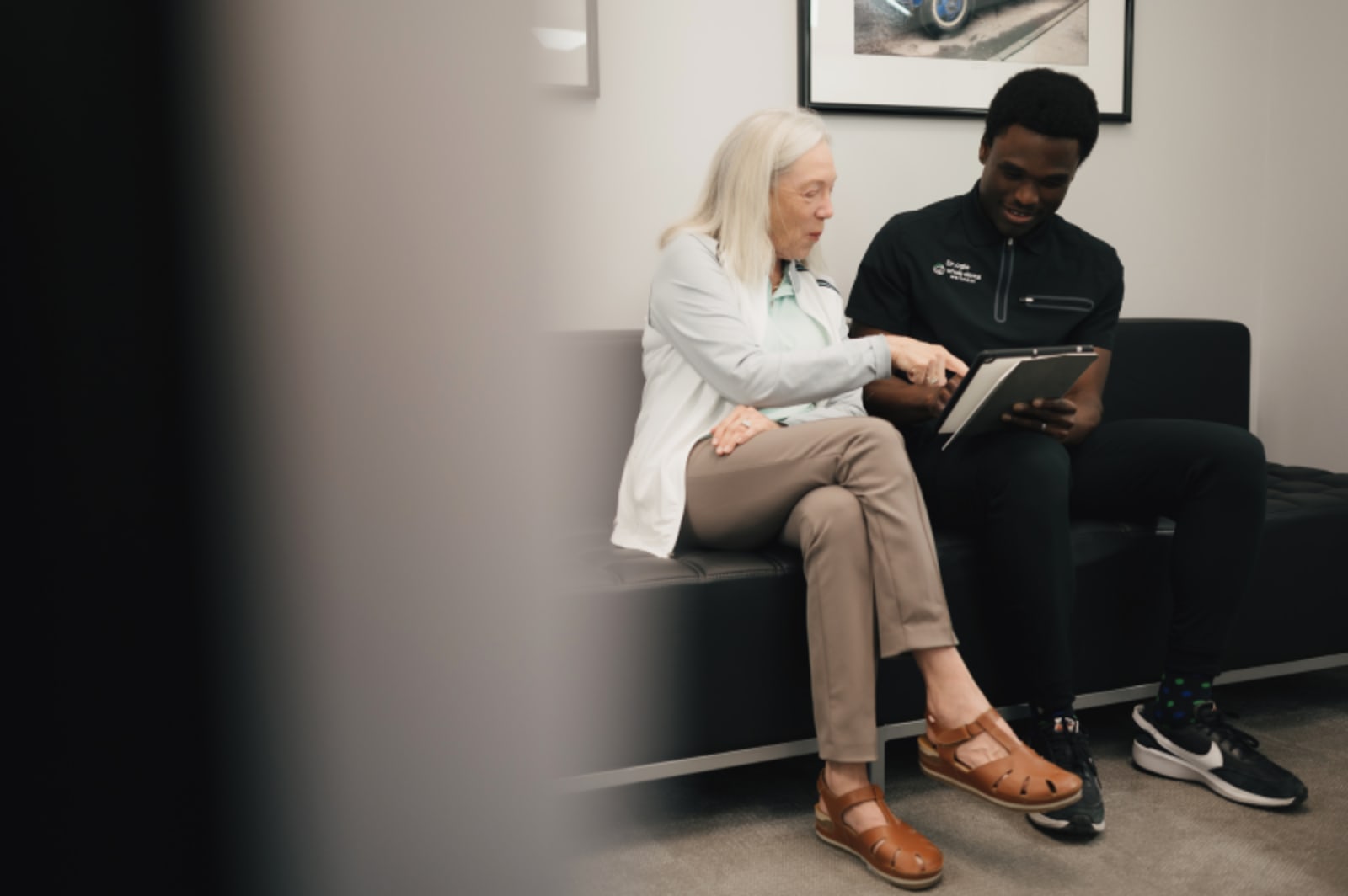 Dentist discussing treatment costs with patient in consultation room at Whole Dental Wellness.