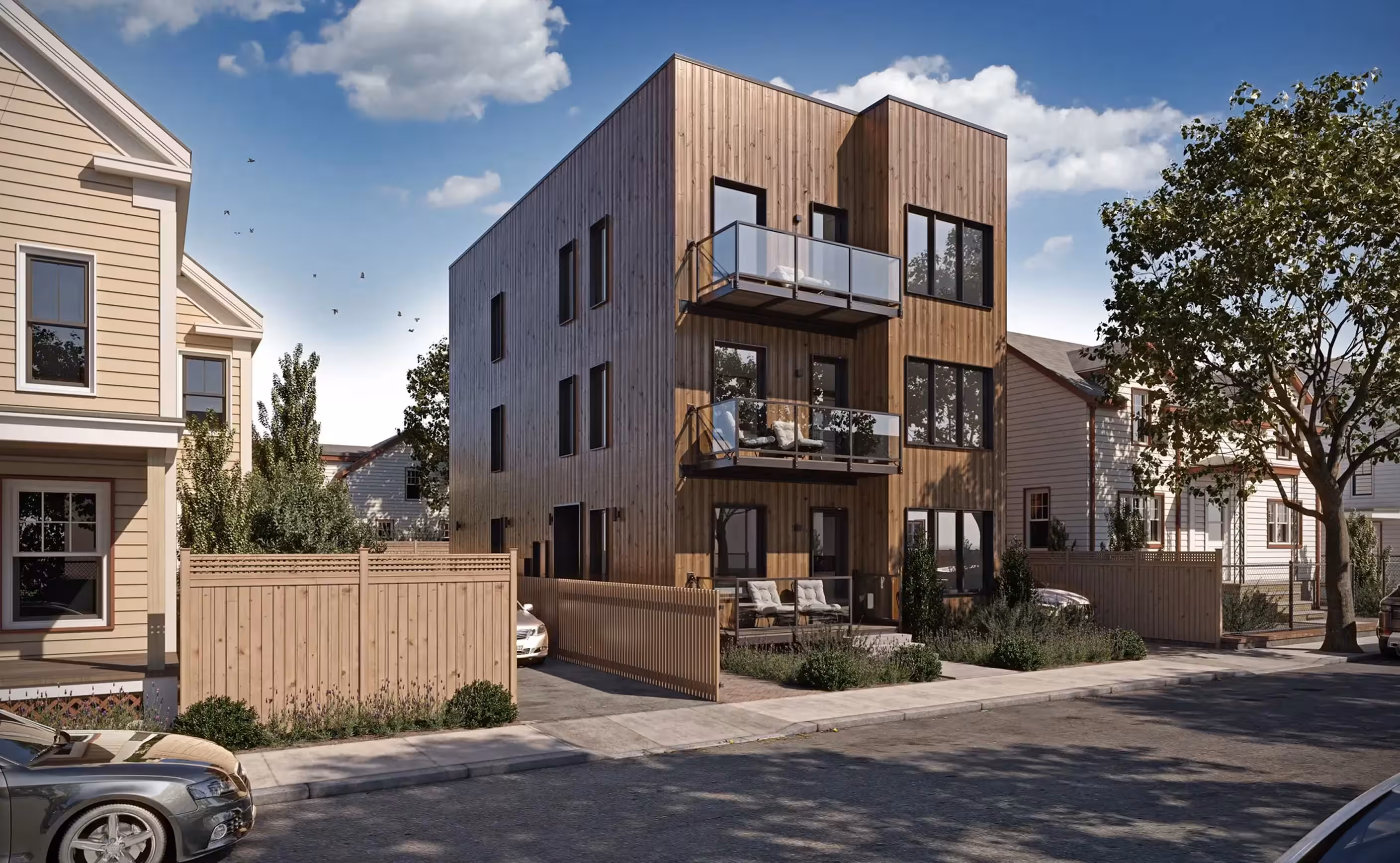 Modern three-story wooden house with balconies and outdoor seating on a suburban street.