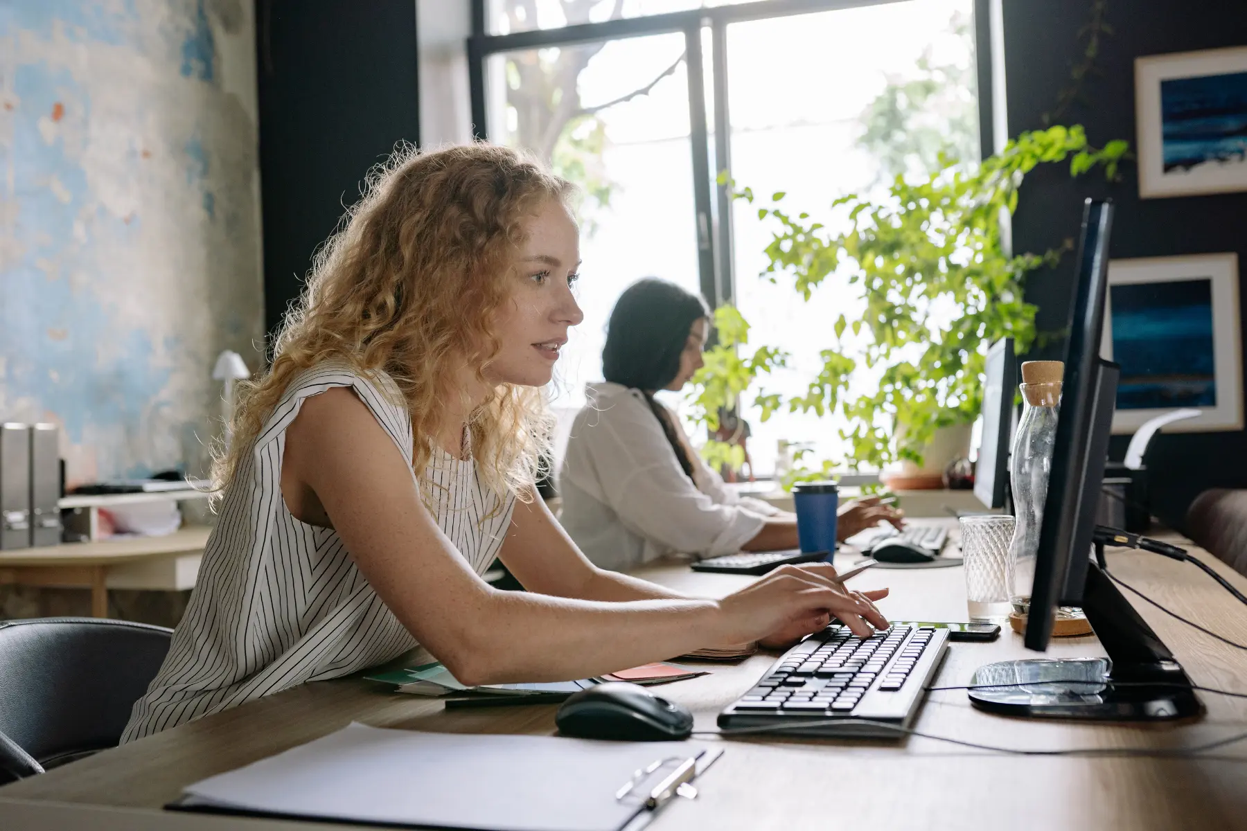 A complaints handler at a desk working through a case on screen