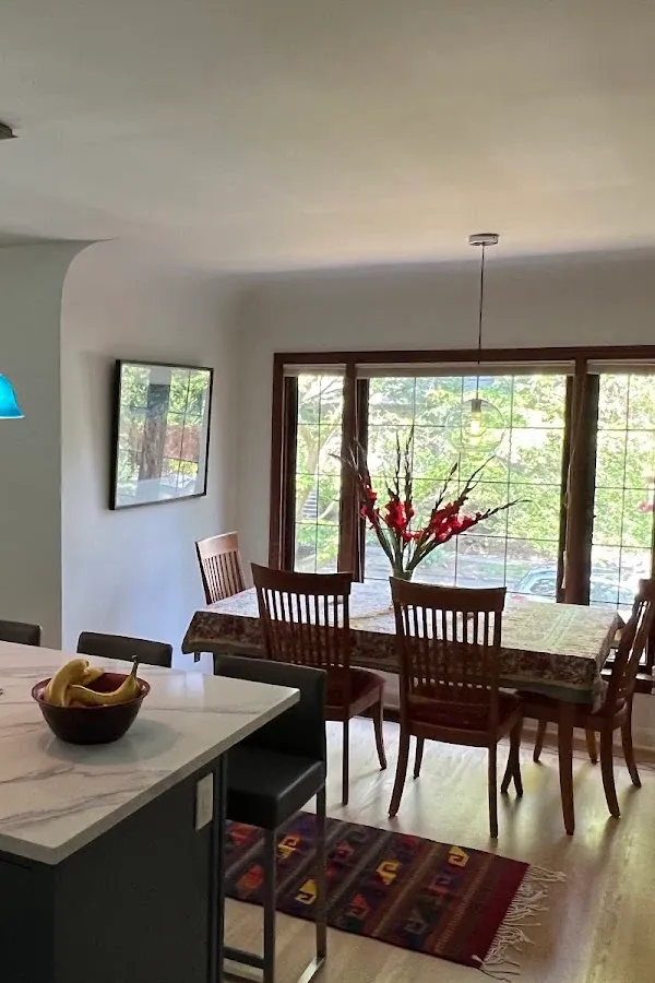Dining area beside a kitchen island, with glass doors opening to the garden