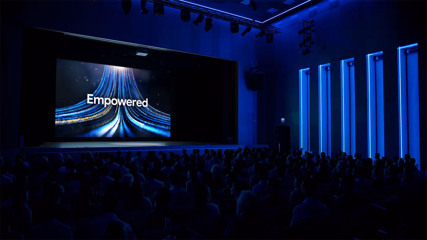 An animation on screen at a large conference town hall presentation