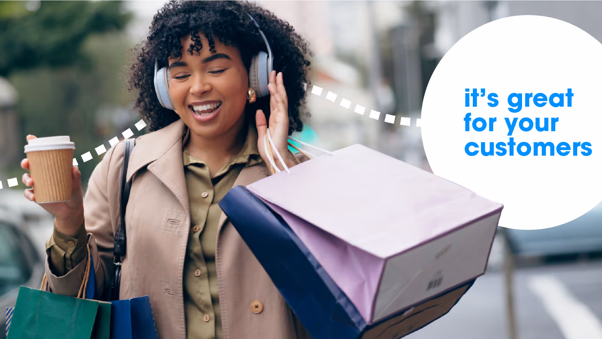 An image of a very happy customer shopping with a coffee in hand