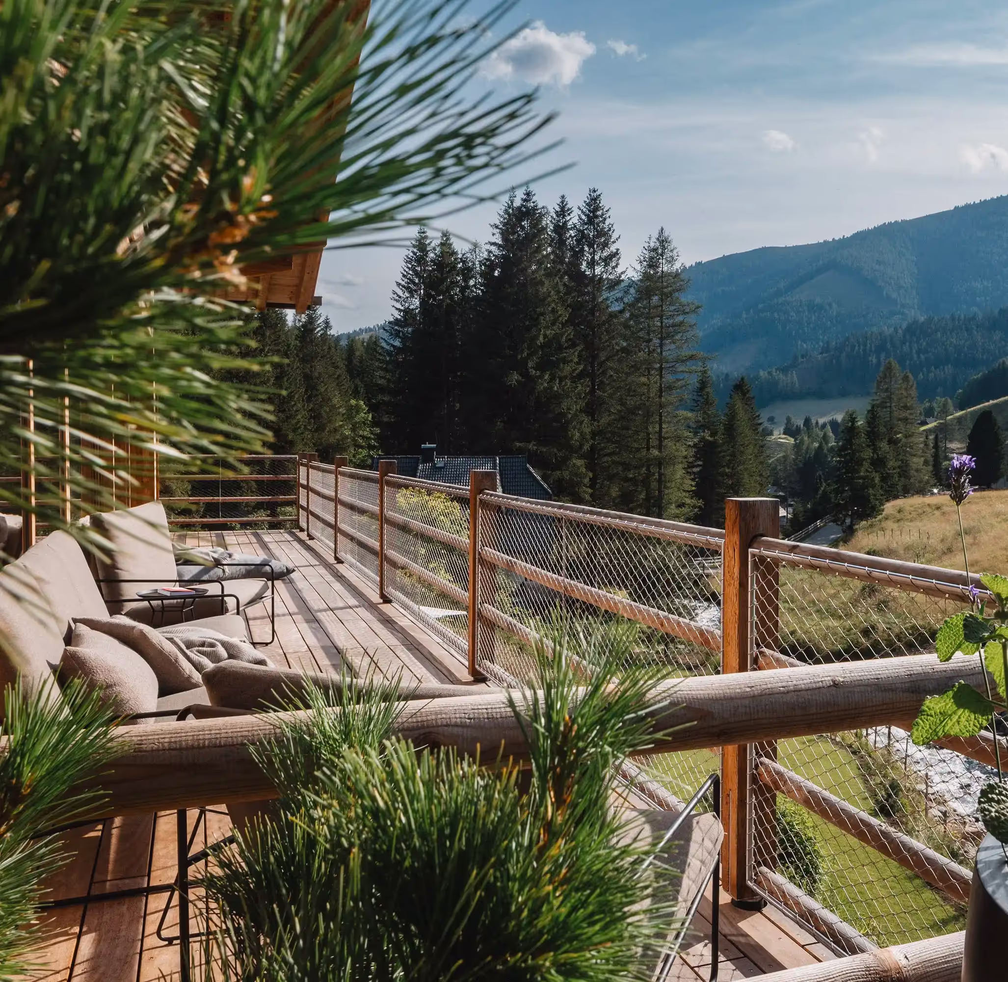 The veranda with lounge seats and panoramic view on the mountains
