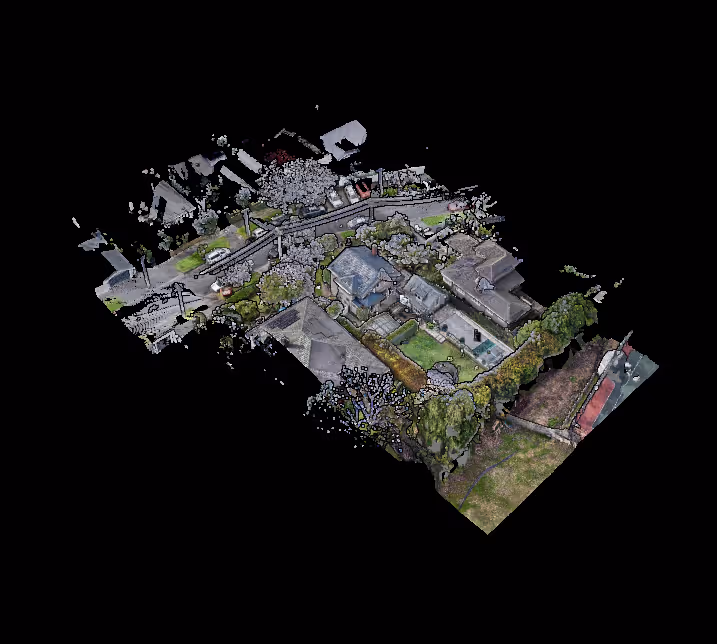 Aerial 3D view of a residential neighbourhood showing houses, trees, roads, and parked cars.