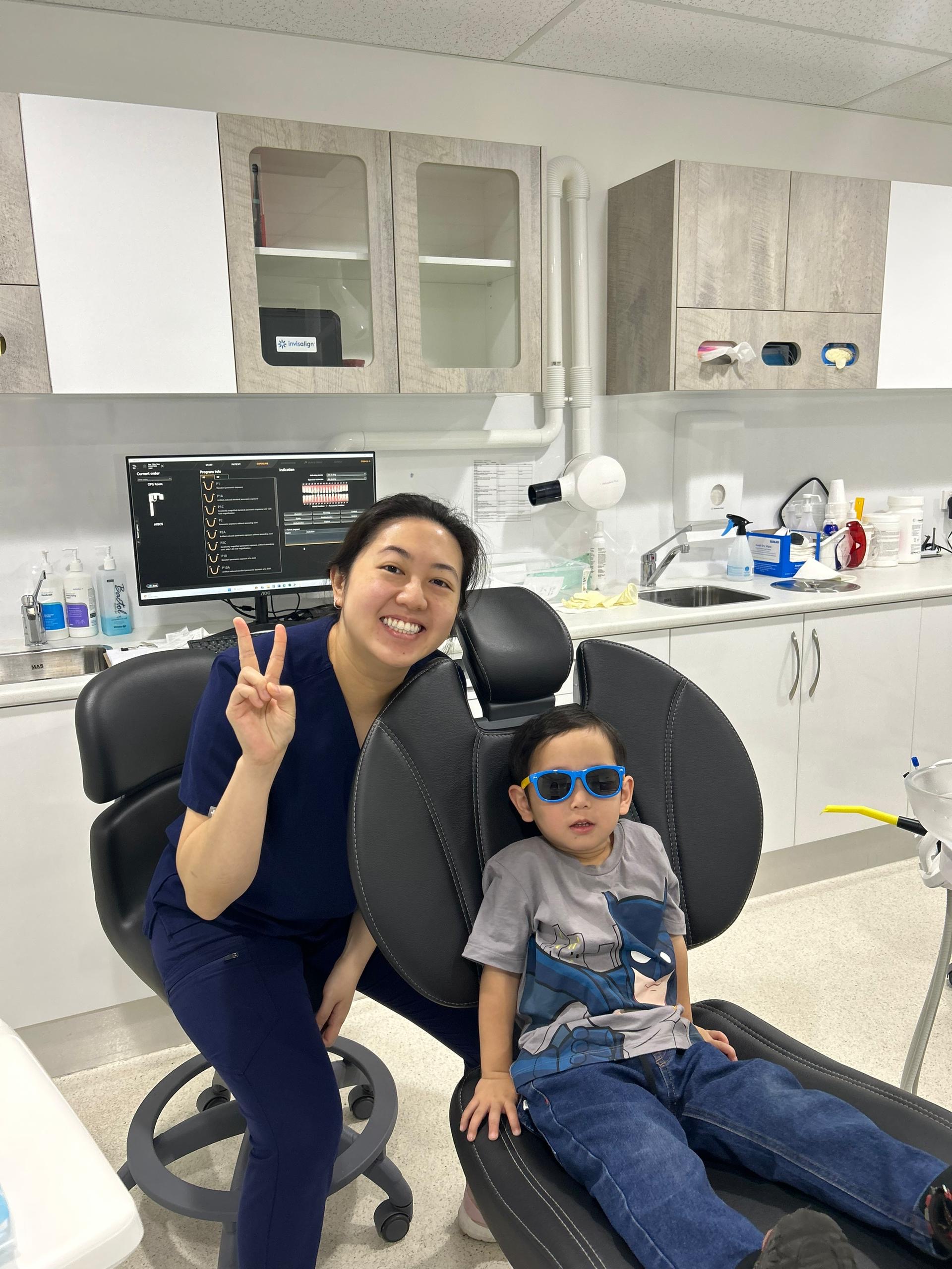 Smiling dentist and child patient in sunglasses at a Perth kid dentistry clinic - JC Dental Como