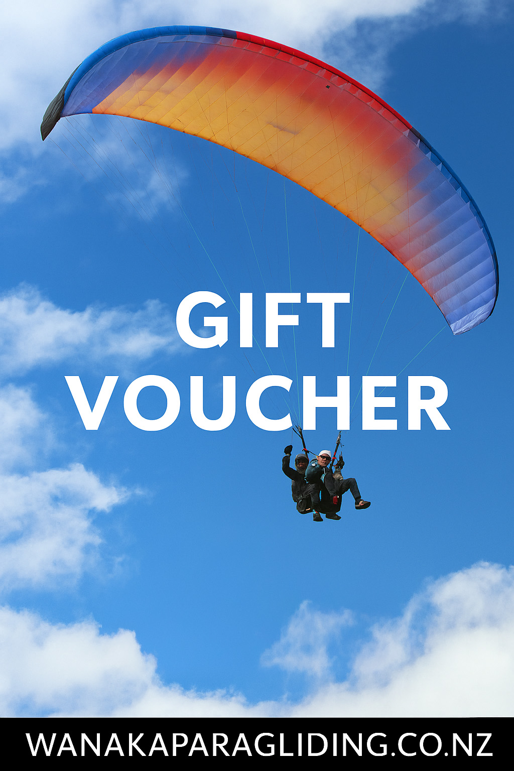 Paraglider soaring above stunning Lake Wānaka with snow-capped mountains and a clear blue sky in the background, showcasing a breathtaking aerial view of the scenic landscape.