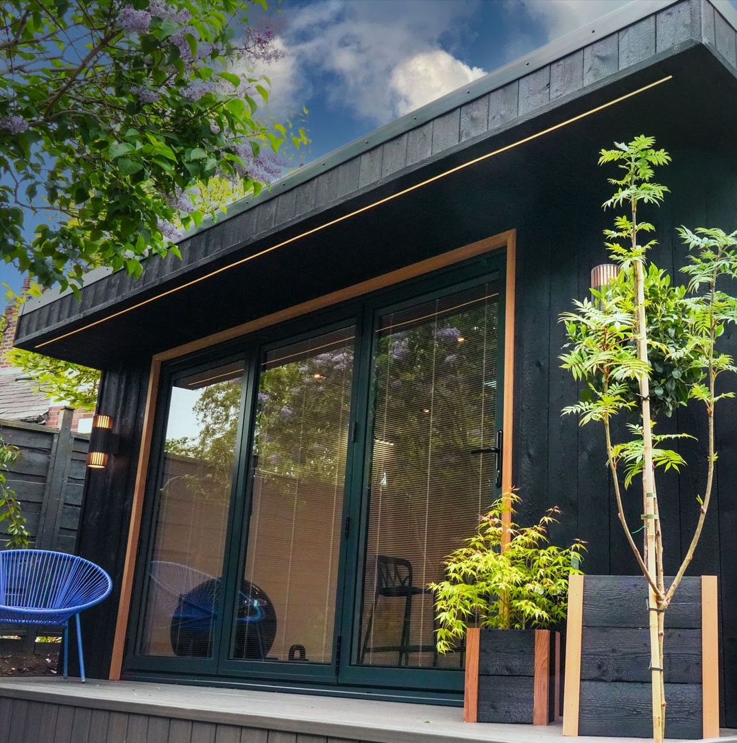 Bold Shou Sugi Ban timber cladding with lantern roof light on garden room