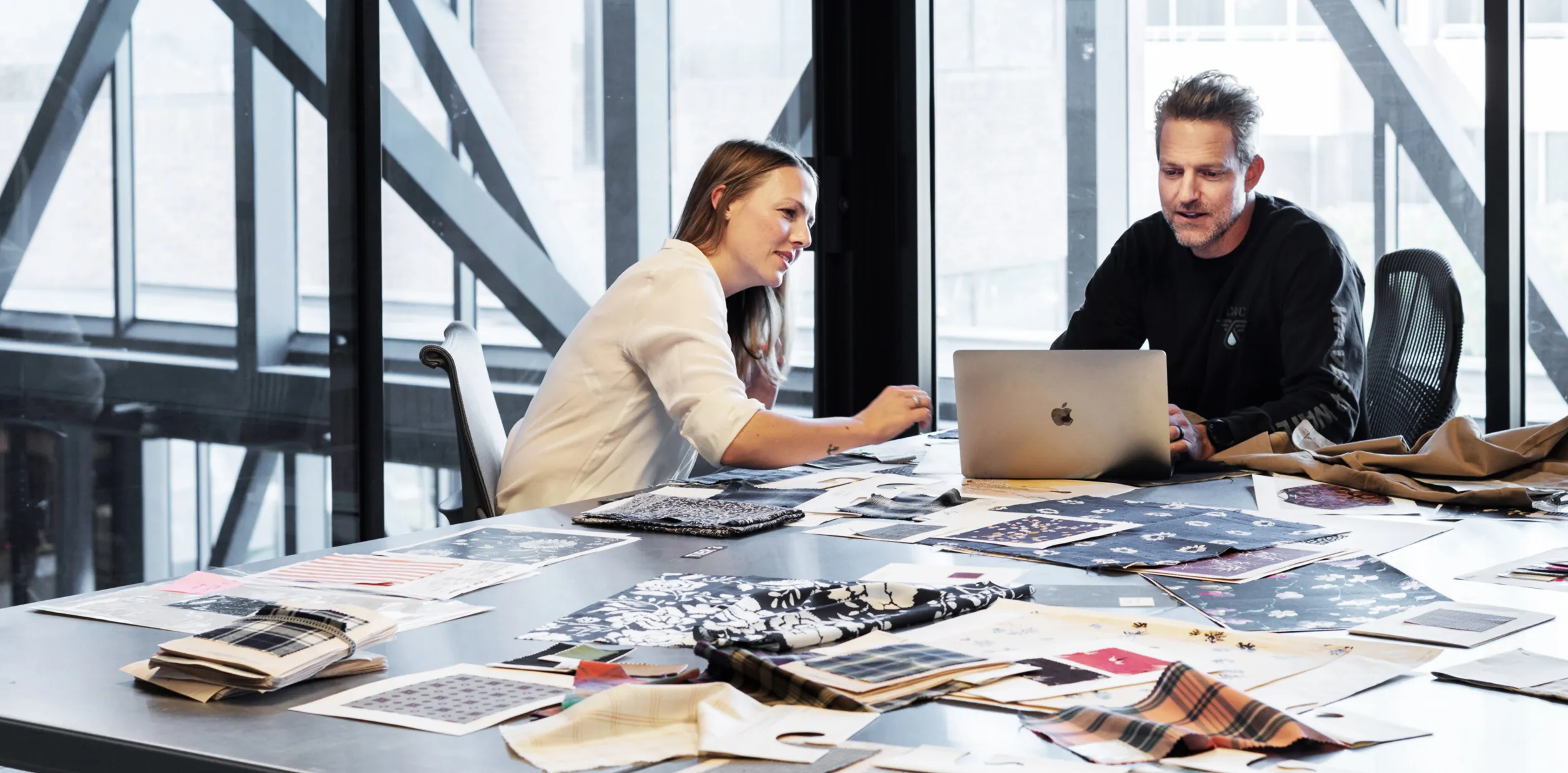Business team working at a table covered with documents