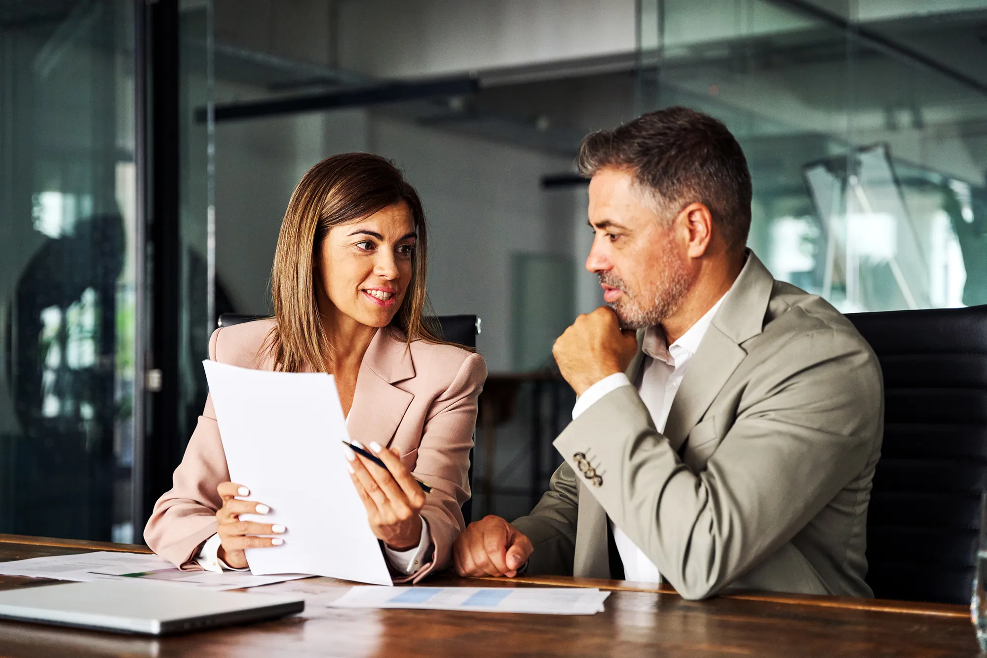 Two business owners reviewing finance documents in a meeting