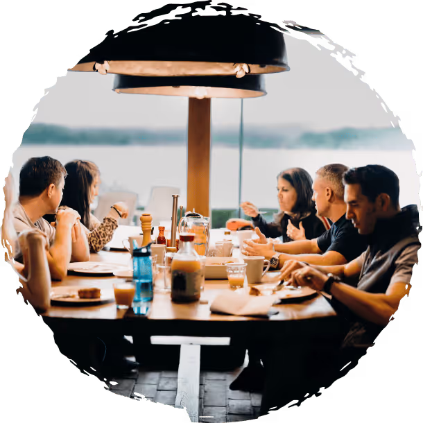 Retreat members enjoying food around the table.