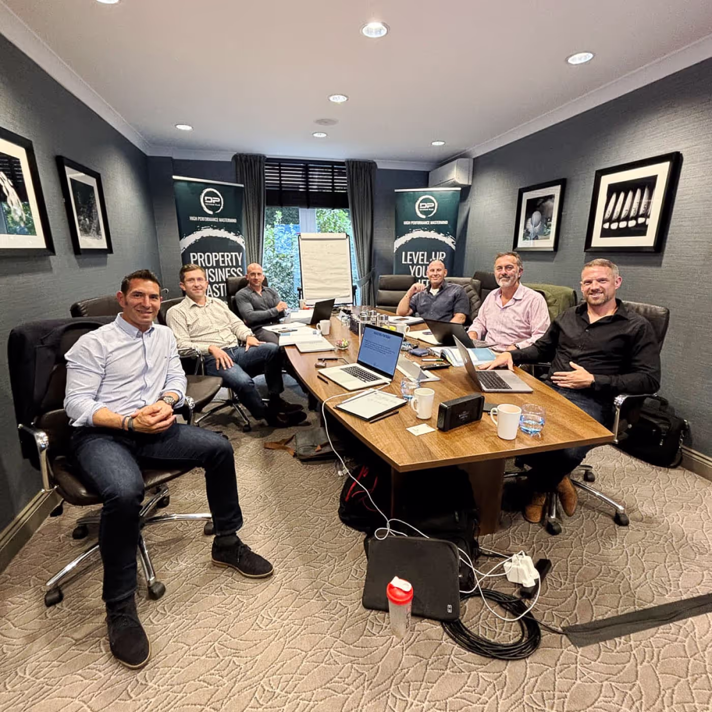 Mastermind delegates sitting round a board table.