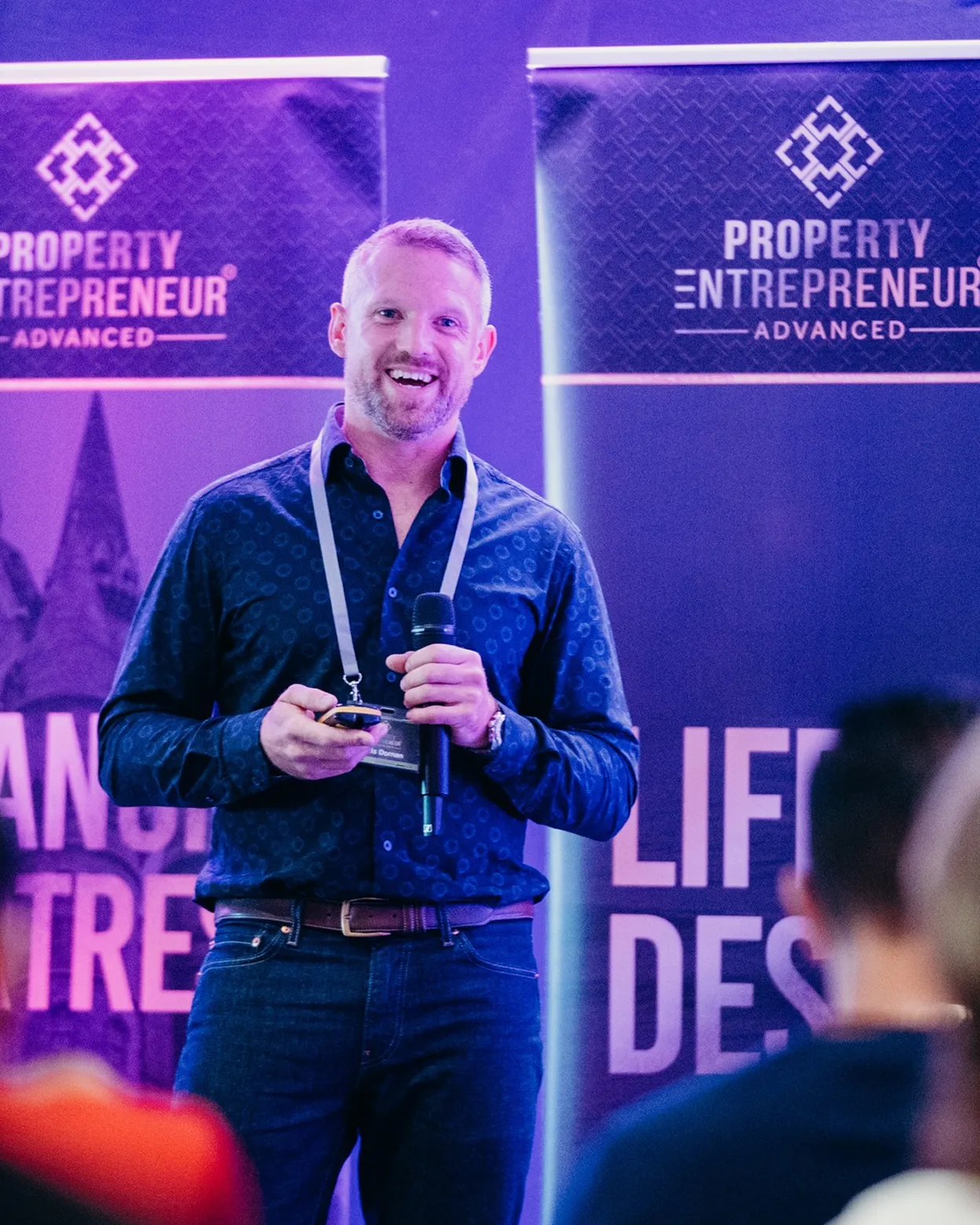 Chris on stage at property entrepreneur giving a speech