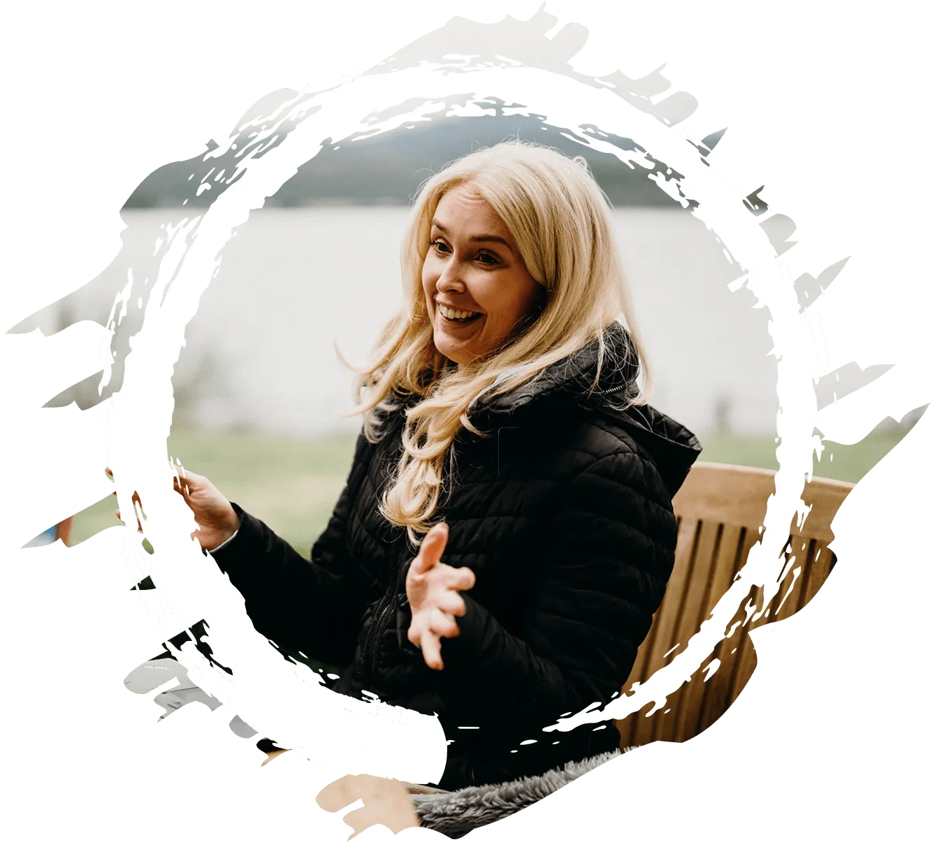 A woman sitting on a bench with a smile on her face.