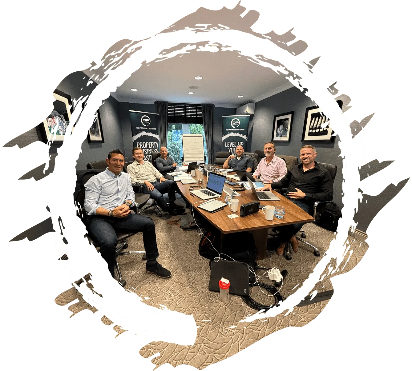 Mastermind delegates sitting round a board table.