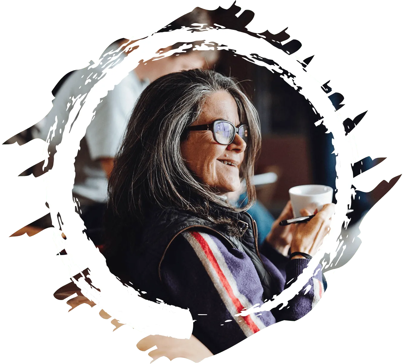 Retreat member sitting on a couch holding a cup of coffee.