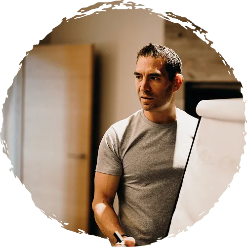Tsen standing next to a whiteboard giving a workshop