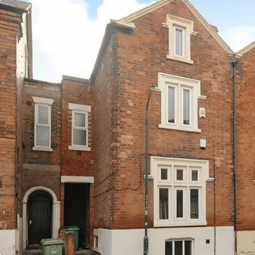 A row of brick buildings with white windows.