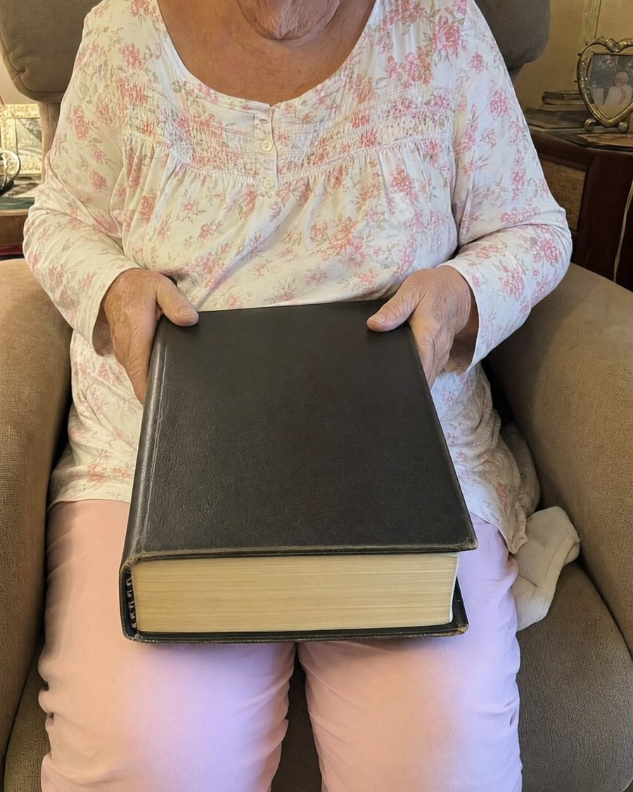 A heavy giant print Bible weighing on a reader's lap