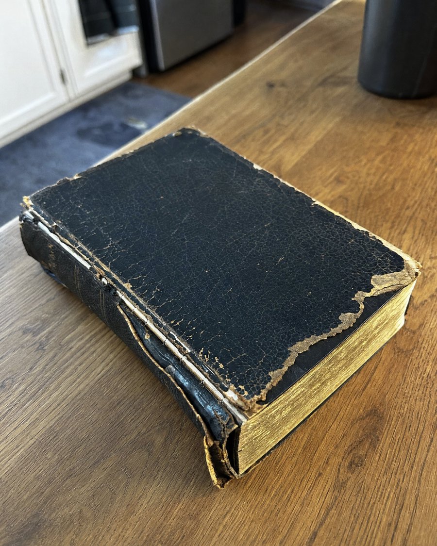 An old Bible with a cracked, peeling cover