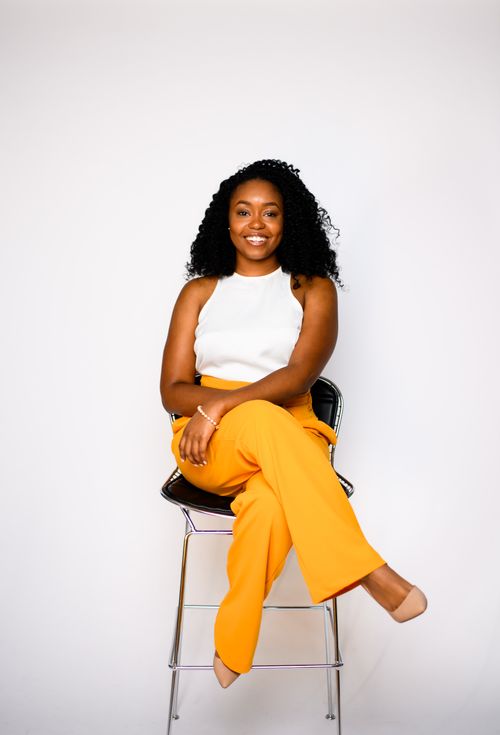 Danielle Deavens seated and smiling at the camera (headshot)